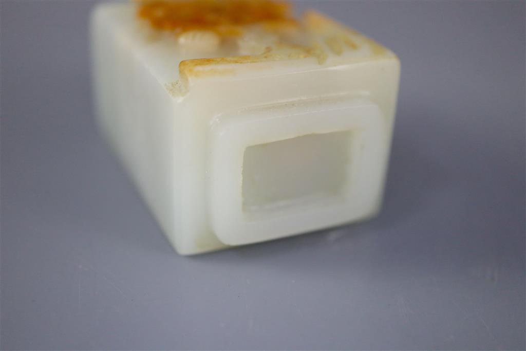 A Chinese pale celadon and russet jade rectangular snuff bottle, 19th century, 5.7cm excl. stopper